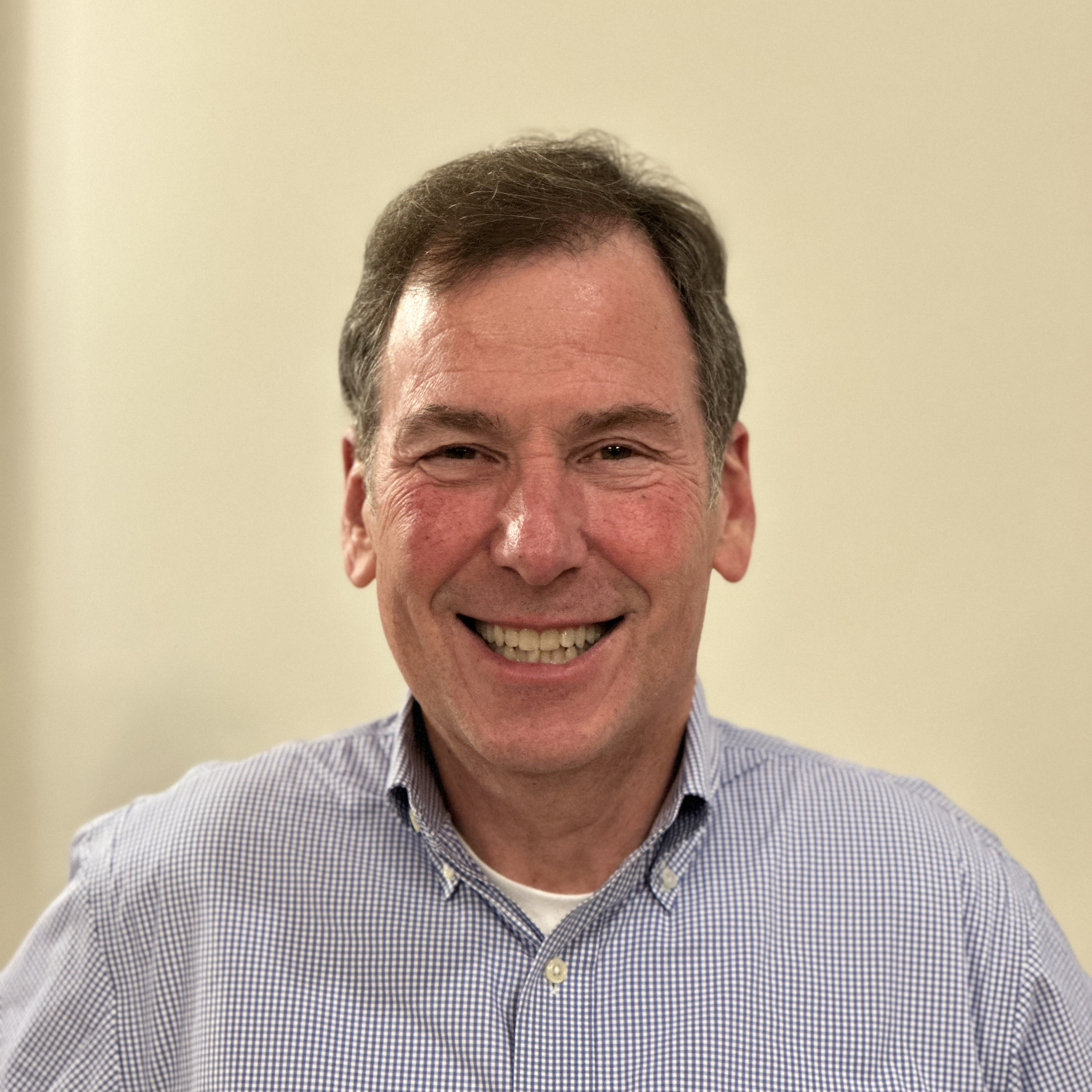 Headshot image of a man smiling.