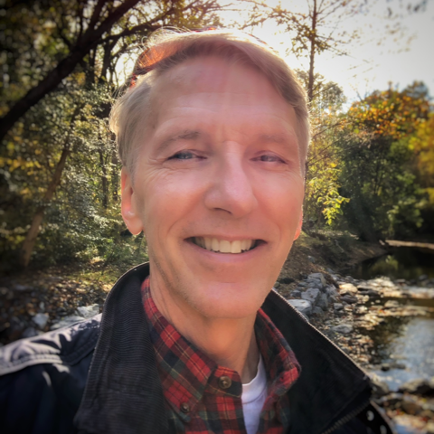 Headshot image of a man smiling.