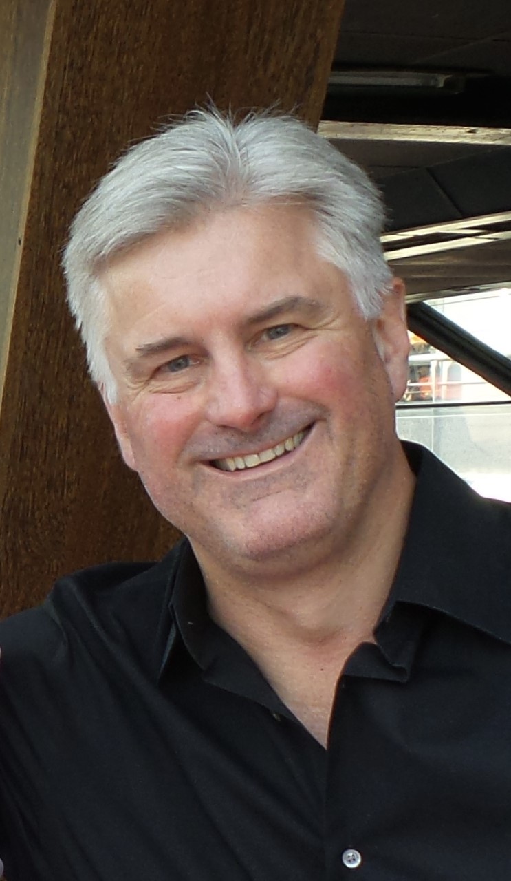 Headshot image of a man smiling.