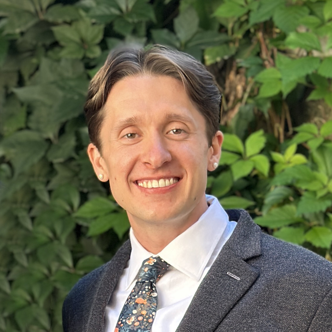 Headshot image of a man smiling.